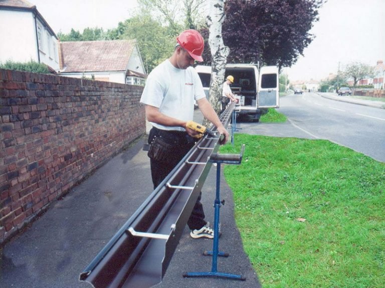 two men fixing seamless guttering