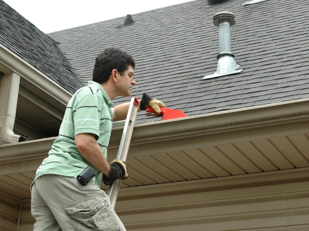 man inspecting seamless guttering